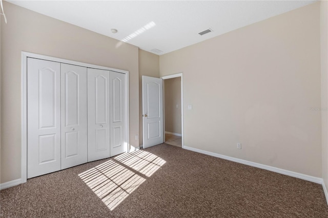 unfurnished bedroom with a closet and carpet