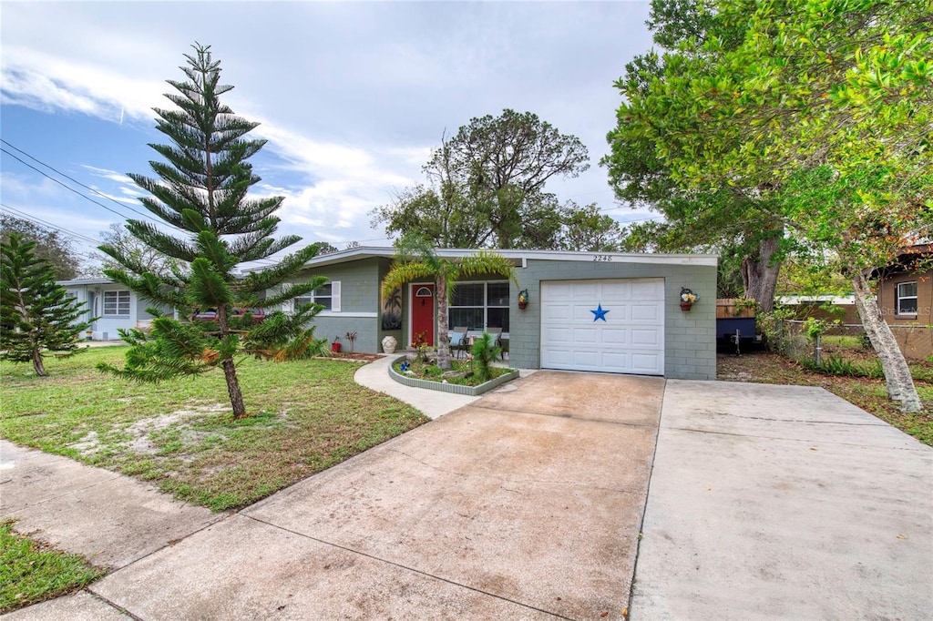 ranch-style house featuring a front lawn and a garage