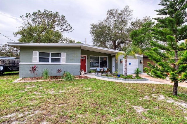 single story home with a front yard, a garage, and covered porch