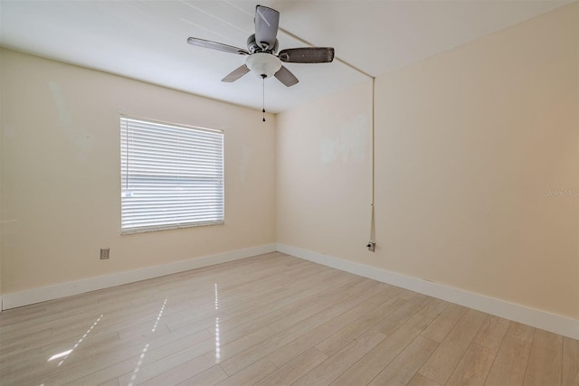 empty room with wood finished floors, baseboards, and ceiling fan