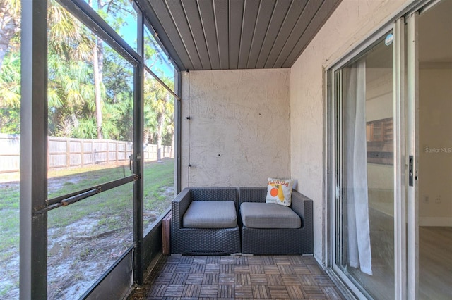 unfurnished sunroom with wood ceiling