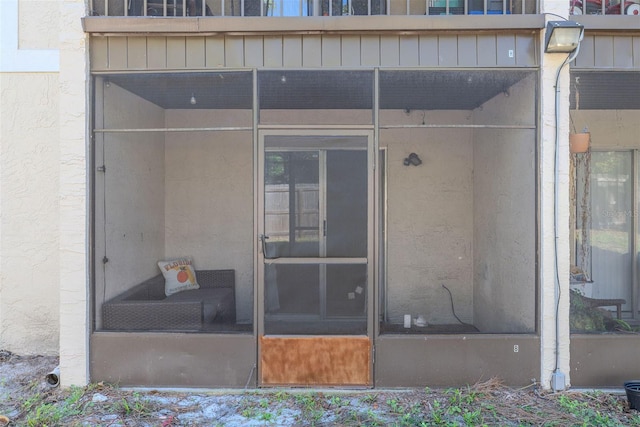 doorway to property with stucco siding