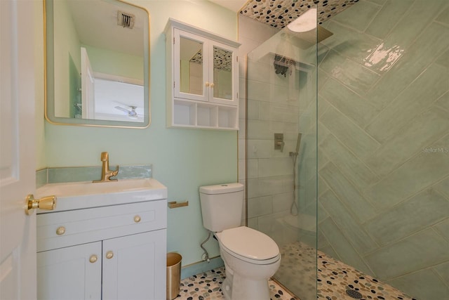 full bath with visible vents, a walk in shower, toilet, and vanity