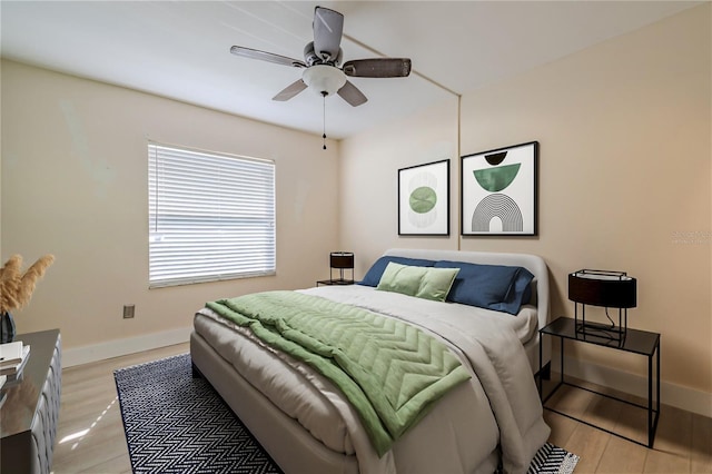 bedroom featuring light wood-style floors, baseboards, and ceiling fan