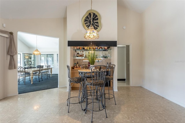 dining room featuring high vaulted ceiling