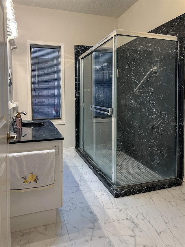 bathroom with vanity and a shower with door