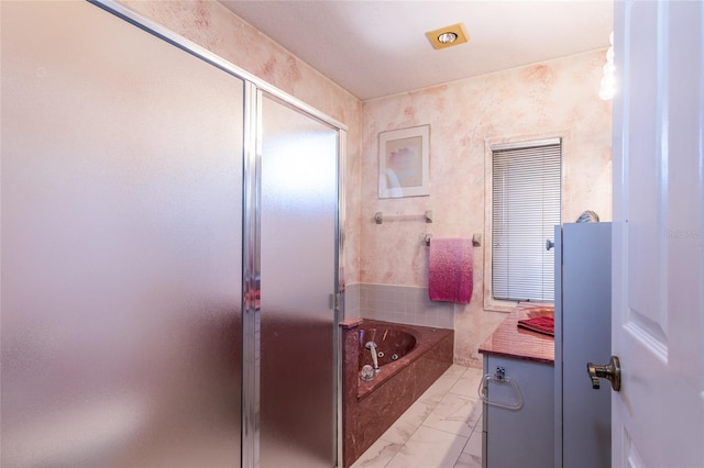 bathroom featuring shower with separate bathtub and vanity