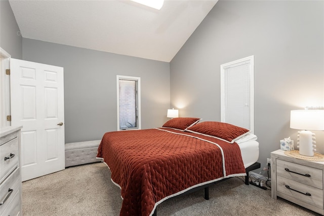 carpeted bedroom featuring vaulted ceiling