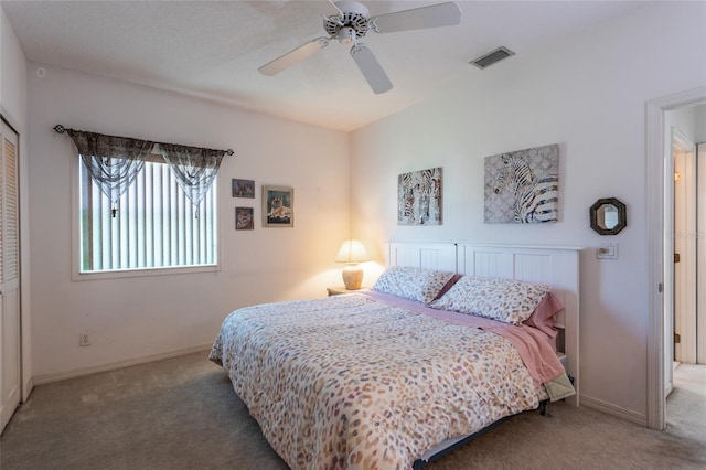 carpeted bedroom featuring ceiling fan and a closet