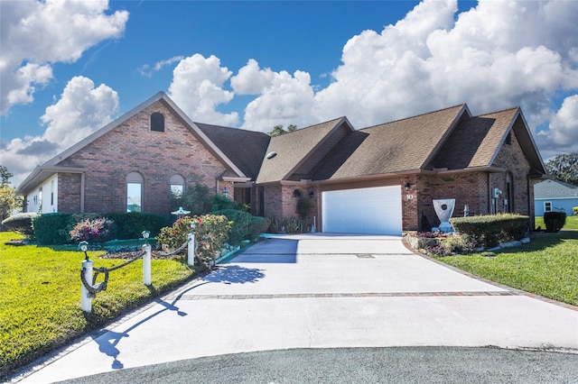 view of front of home with a front yard and a garage