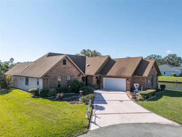 view of front of home with a garage and a front lawn