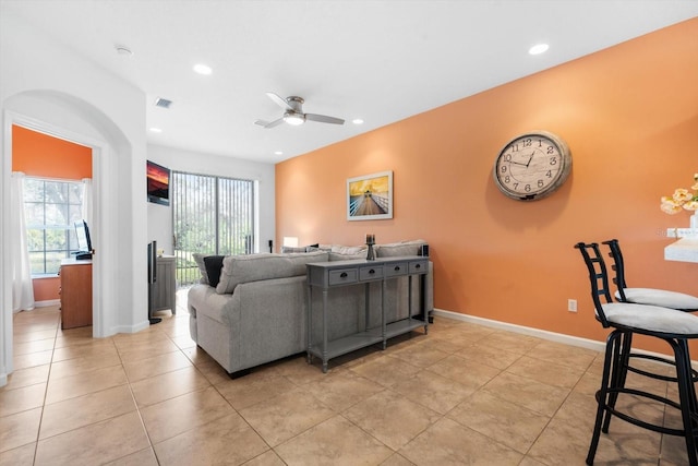 living room featuring ceiling fan and light tile patterned floors