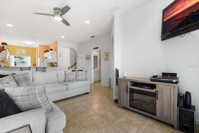 tiled living room with ceiling fan