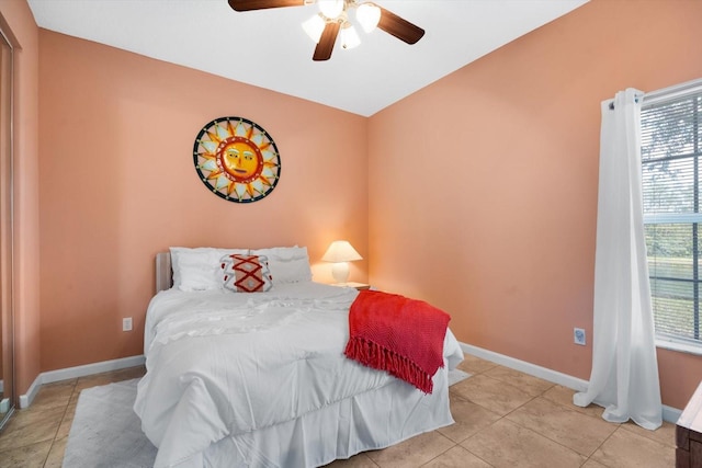 tiled bedroom featuring ceiling fan and vaulted ceiling