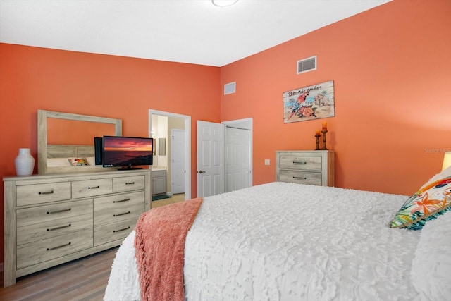 bedroom with hardwood / wood-style floors and a closet