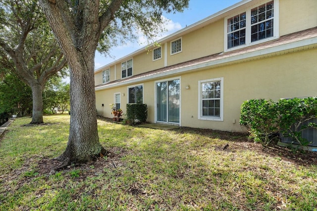 rear view of property with a lawn