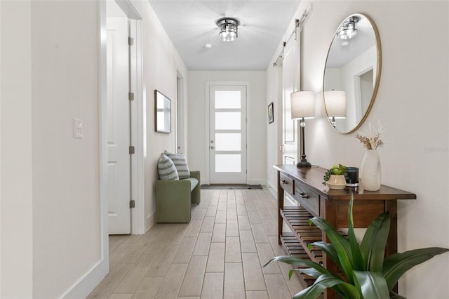 19 Essex Ln, Palm Coast, FL 32164 - interior space featuring baseboards, a barn door, and light wood-type flooring