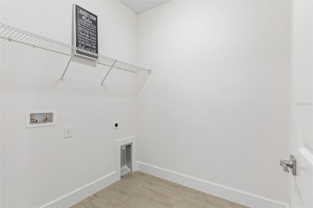 19 Essex Ln, Palm Coast, FL 32164 - laundry room with hookup for a washing machine, light wood finished floors, baseboards, laundry area, and electric dryer hookup