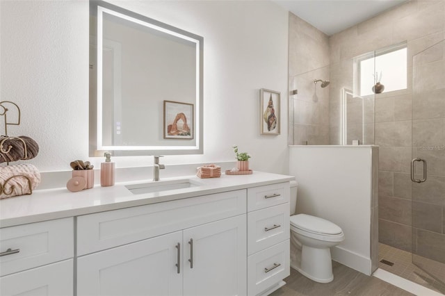 19 Essex Ln, Palm Coast, FL 32164 - bathroom featuring toilet, vanity, wood finished floors, and a shower stall