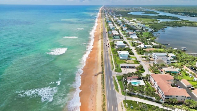 aerial view with a water view and a view of the beach