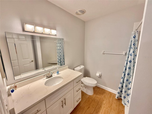 bathroom featuring a shower with shower curtain, vanity, wood-type flooring, and toilet