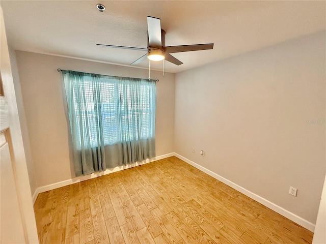 empty room featuring ceiling fan and hardwood / wood-style flooring