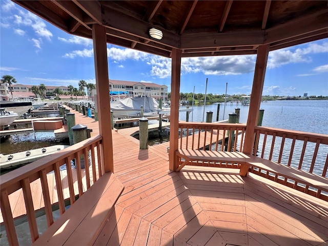 view of dock with a gazebo and a water view