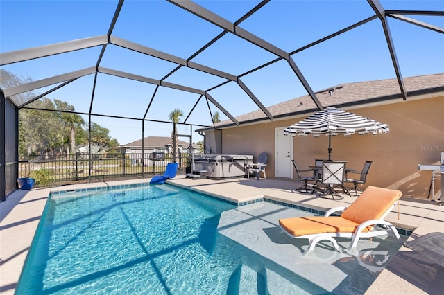 view of swimming pool featuring a lanai, a patio, and a hot tub