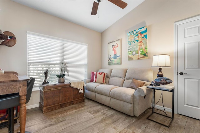 living room featuring ceiling fan, vaulted ceiling, and light hardwood / wood-style flooring