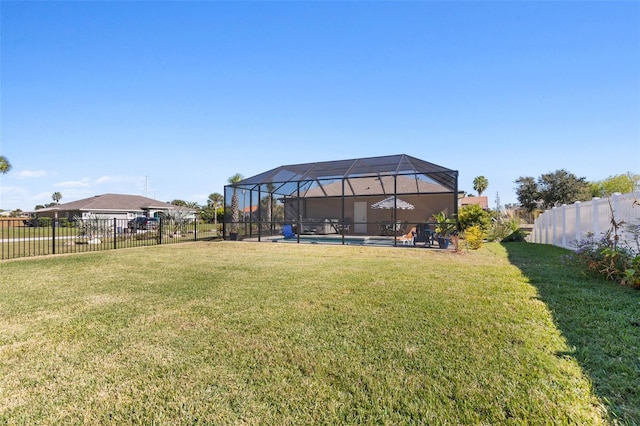 view of yard with glass enclosure and a pool