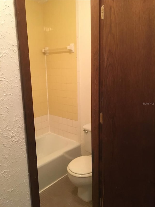 bathroom featuring toilet and tile patterned floors