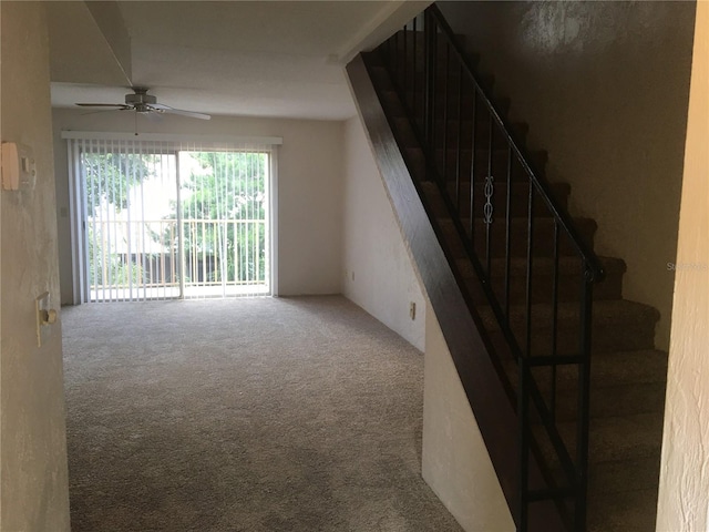 interior space with carpet floors and ceiling fan