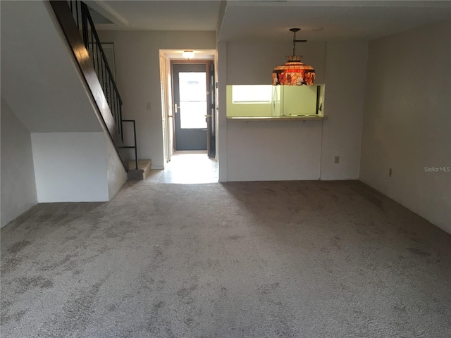 unfurnished room featuring light carpet