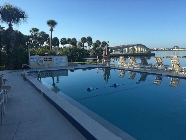 view of swimming pool featuring a water view