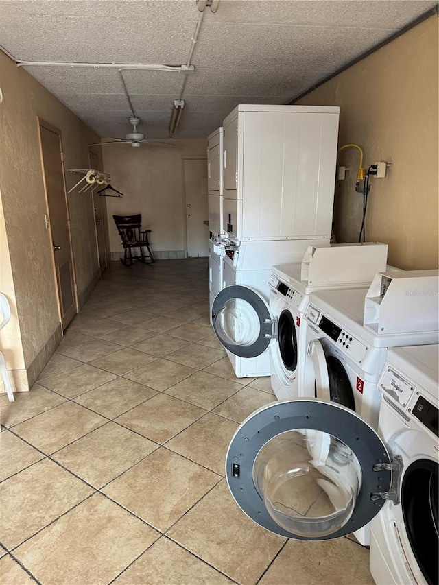 laundry area featuring light tile patterned floors, stacked washer / dryer, and separate washer and dryer