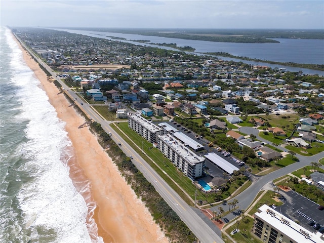 bird's eye view featuring a water view and a view of the beach