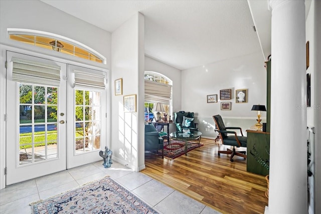 entrance foyer featuring light hardwood / wood-style floors and french doors