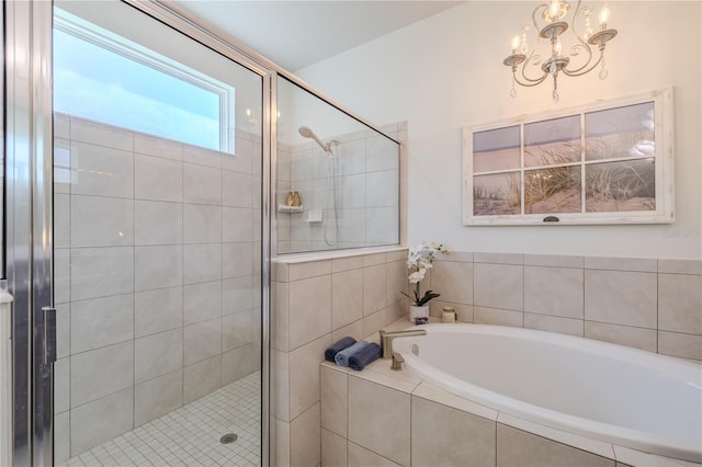 bathroom featuring independent shower and bath and a notable chandelier