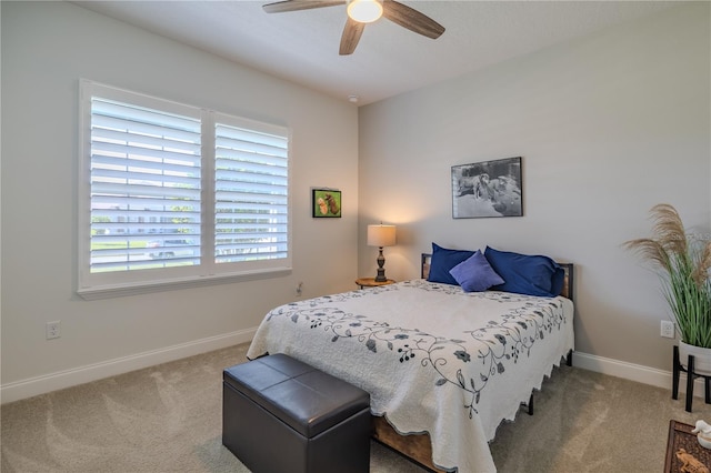 bedroom featuring ceiling fan and carpet