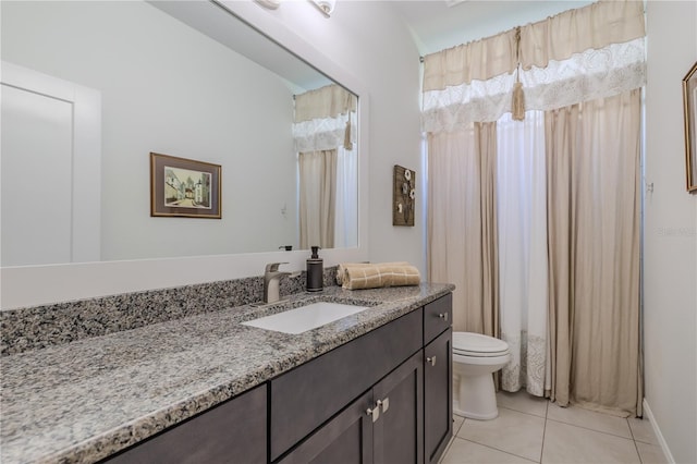 bathroom with tile patterned flooring, vanity, and toilet