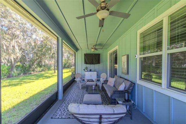 sunroom featuring ceiling fan