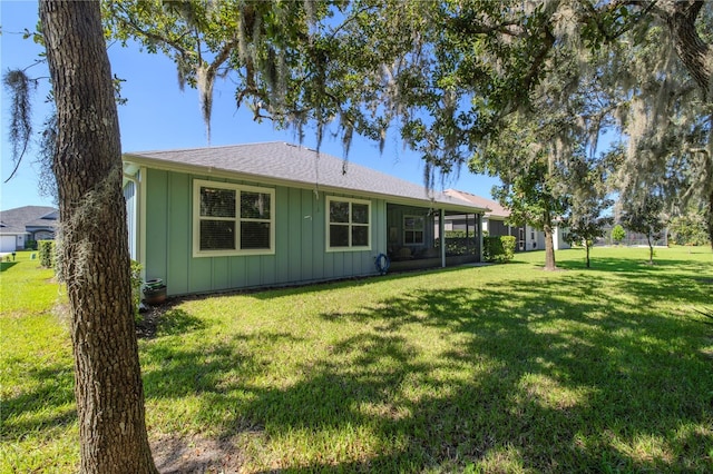 rear view of house featuring a yard