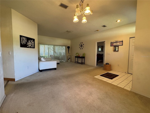 unfurnished living room with light colored carpet, a textured ceiling, and a chandelier