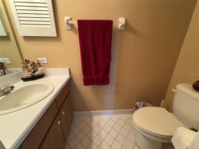 bathroom featuring tile patterned floors, vanity, and toilet