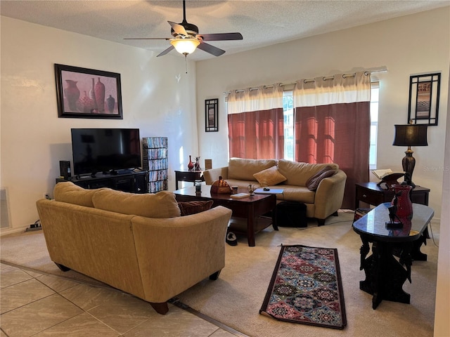 living room with light tile patterned floors, a textured ceiling, and ceiling fan