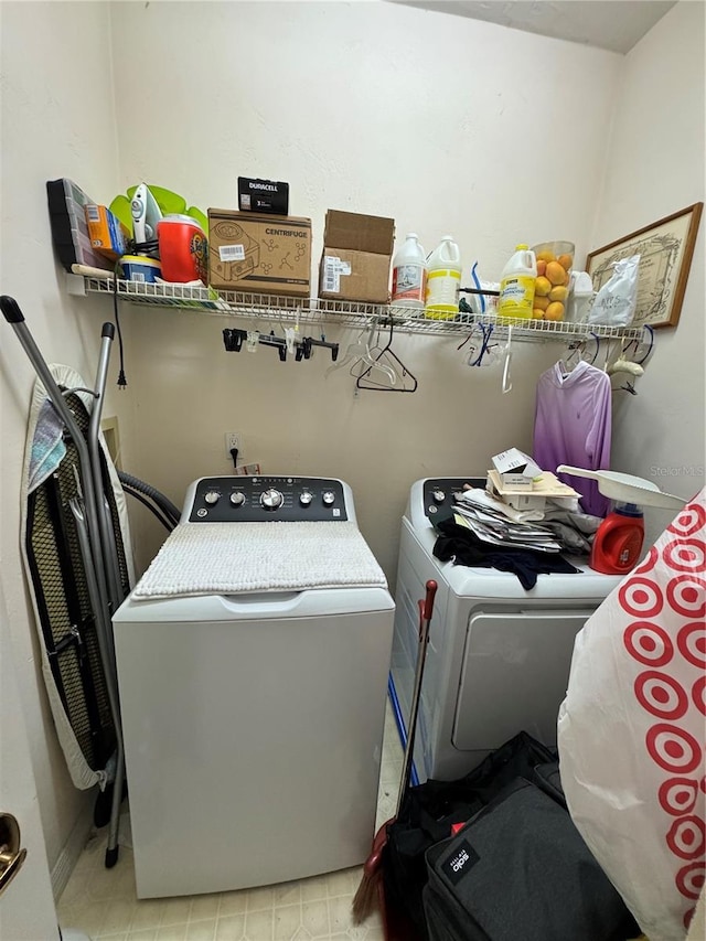 clothes washing area with washing machine and clothes dryer