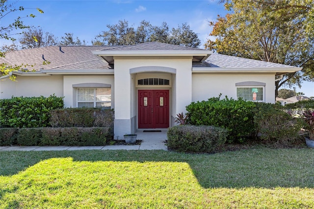 doorway to property with a lawn