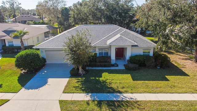 view of front facade with a front yard and a garage