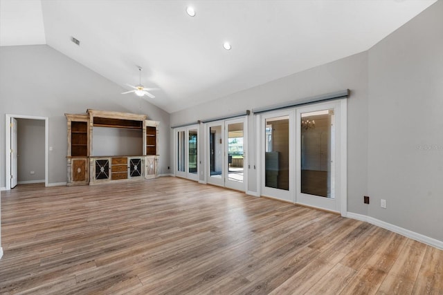 unfurnished living room featuring high vaulted ceiling, light hardwood / wood-style flooring, and ceiling fan