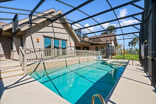 view of swimming pool with an in ground hot tub, glass enclosure, and a patio area